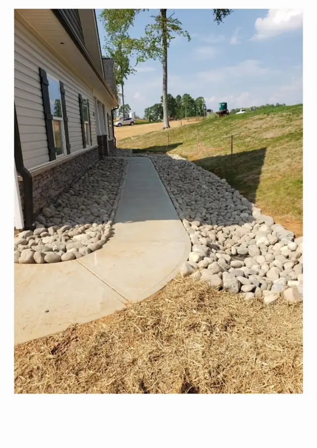Finished drainage and stonework beside a home in Charlotte, NC