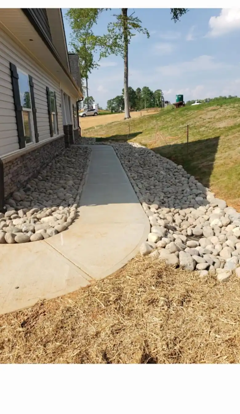 River rock drainage path installed along a home in Charlotte, NC