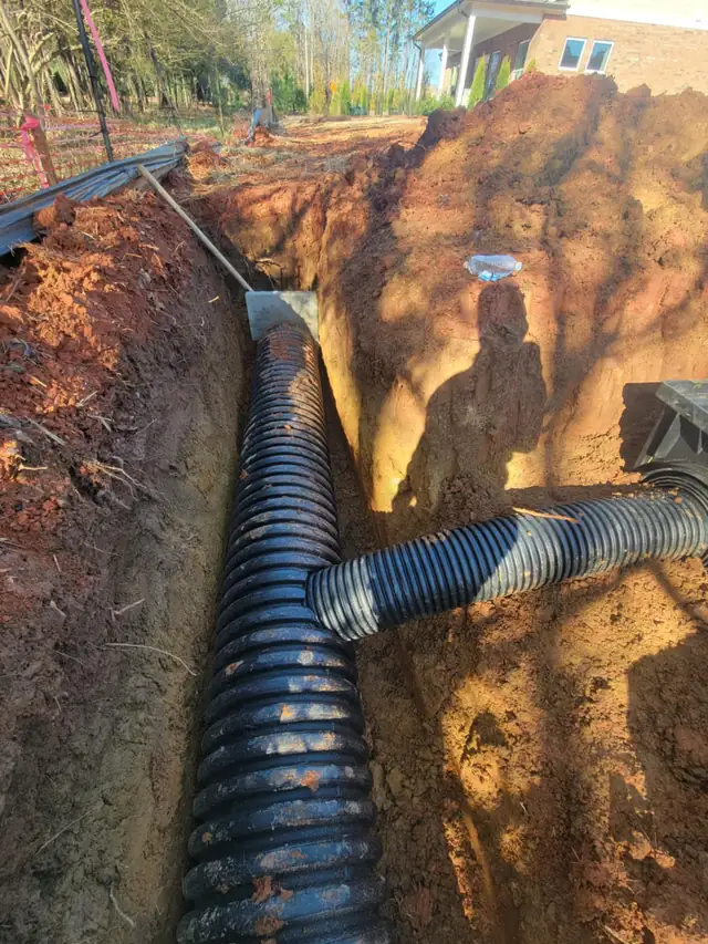 Trenching for a drainage pipe along a road in Charlotte, NC