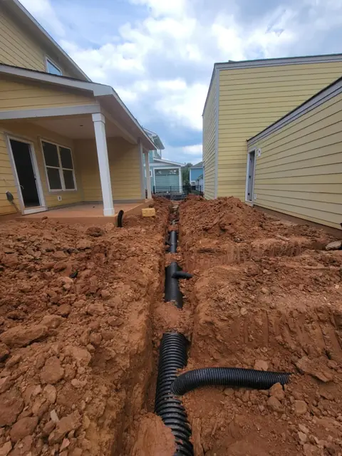 Underground irrigation trenching between two homes in Charlotte NC