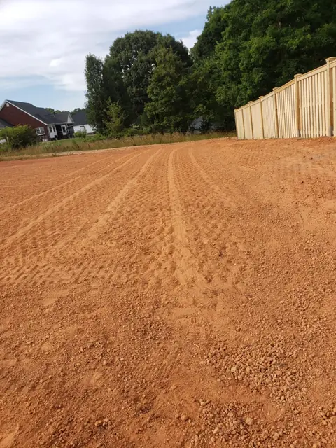Graded lot along a wood privacy fence in Charlotte NC